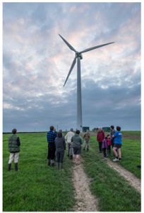 Photo of people standing in the field around Abergwaun Community Turbine